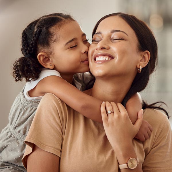 mother and young daughter smiling