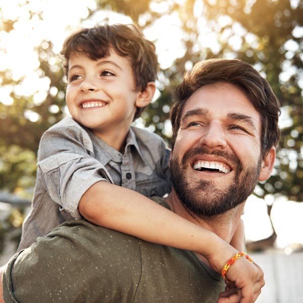 father and young son smiling