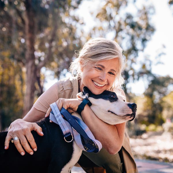 woman hugging dog